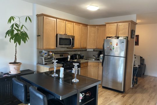 One bedroom with washer/dryer and home office in elevator building